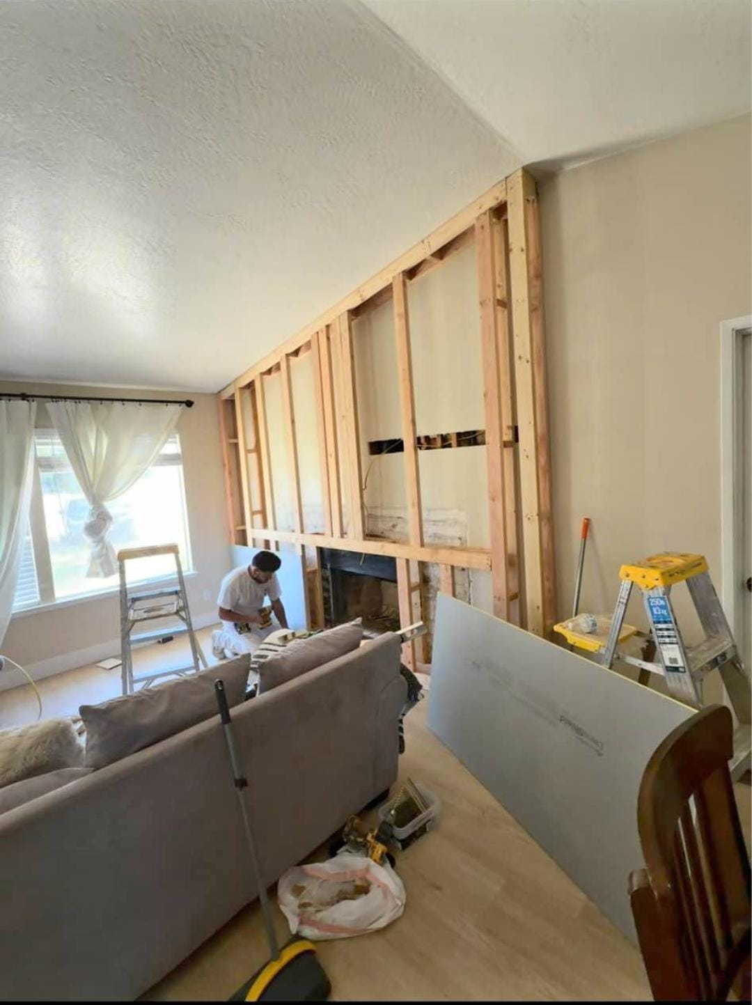 Living room remodel with a new framed feature wall around the fireplace