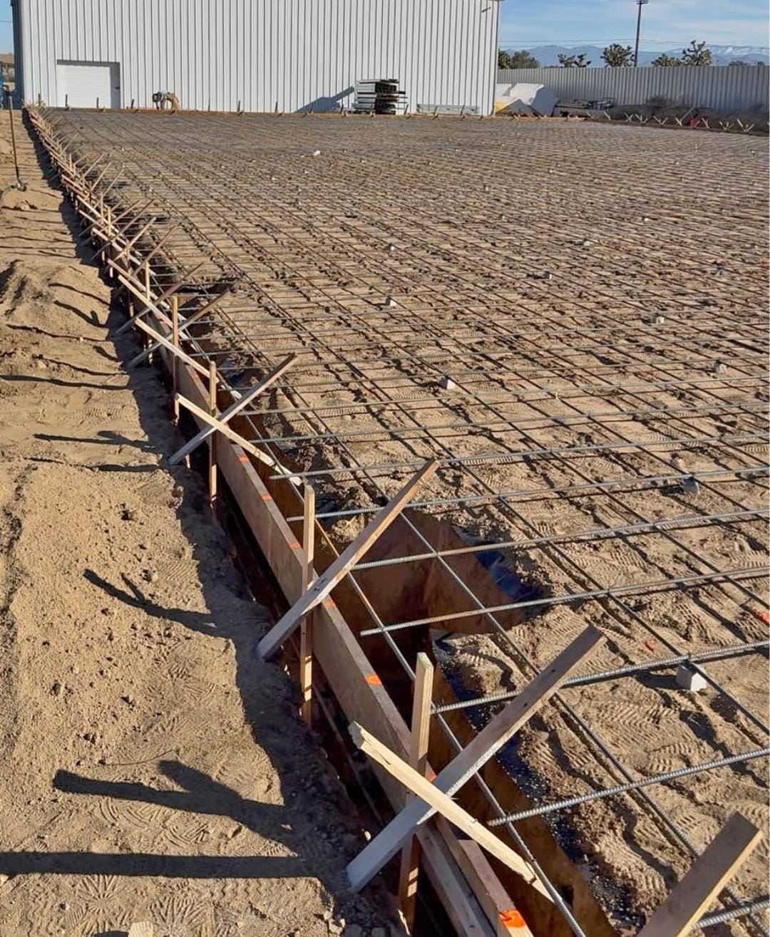 Foundation forms and slab reinforcement prepared on a new construction site